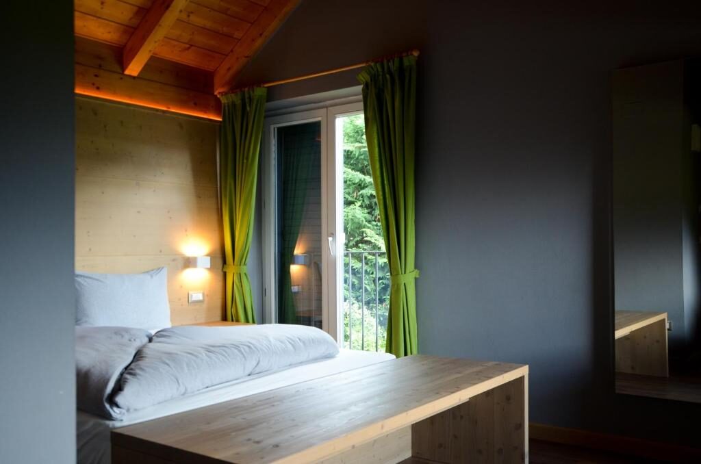 Bedroom with green curtains and mountain outlook